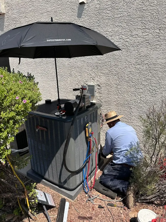 HVAC technician performing outdoor AC maintenance in Silver Firs